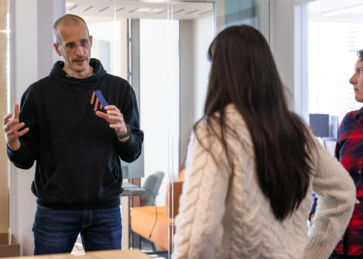 Team members engaged in a discussion in the office, reflecting collaboration and open communication at work.